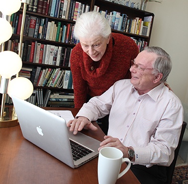 senior man and woman using computer